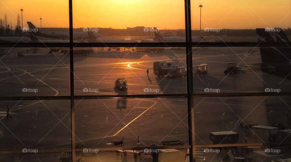 Midnight flight. . This shot was done in Moscow Sheremetievo airport. The Sun was going down when I saw a small figure walking among...