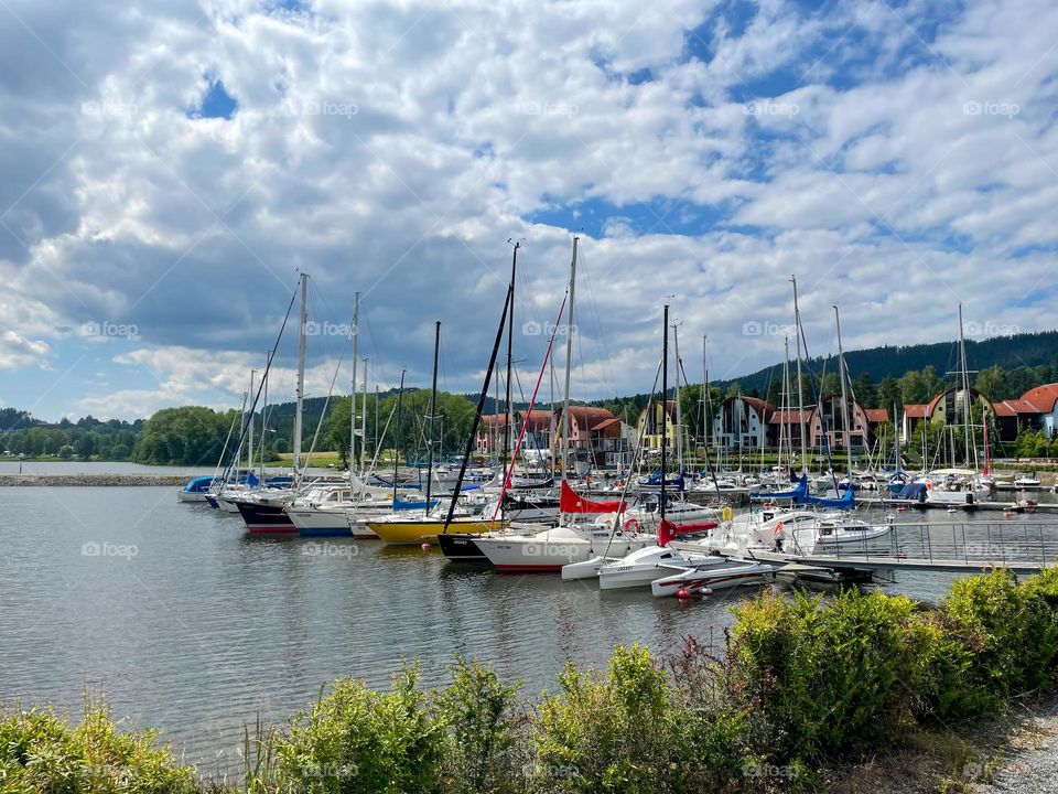 Larger number of boats in the port on the Lipno dam in the village of Lipno in the hotel resort.