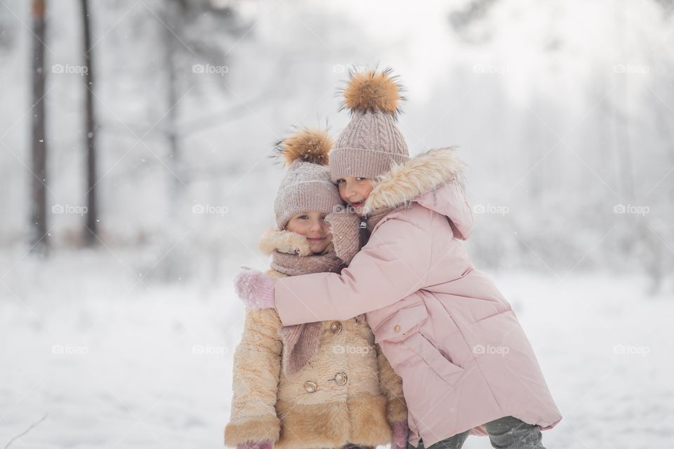 Little sisters in a winter park