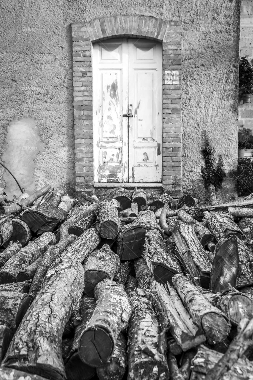 Wood in front of old house