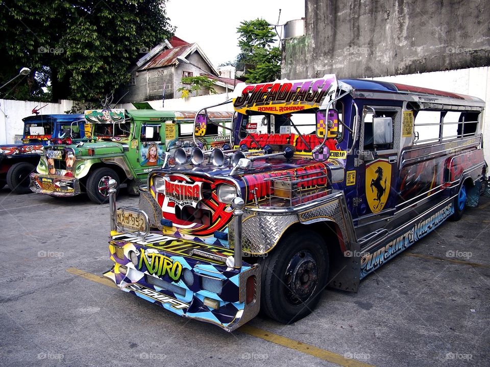 colorful passenger jeepneys parked at a jeepney park