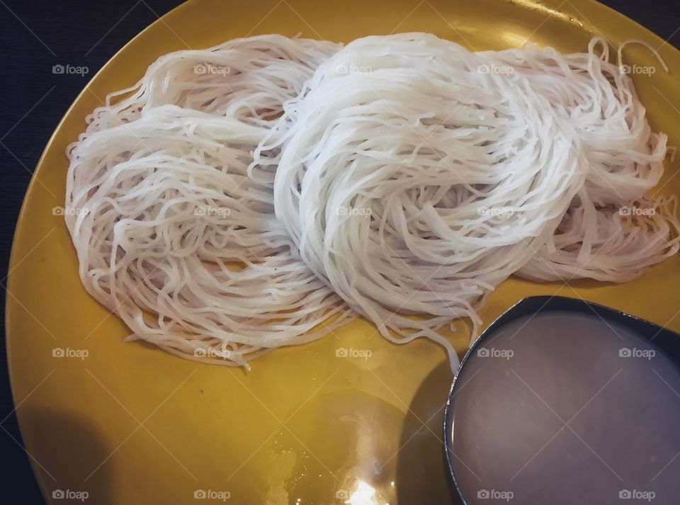 Idiyappam or String hoppers a traditional Tamil, Kerala, Sri Lankan food consisting of rice flour pressed into noodle form and then steamed