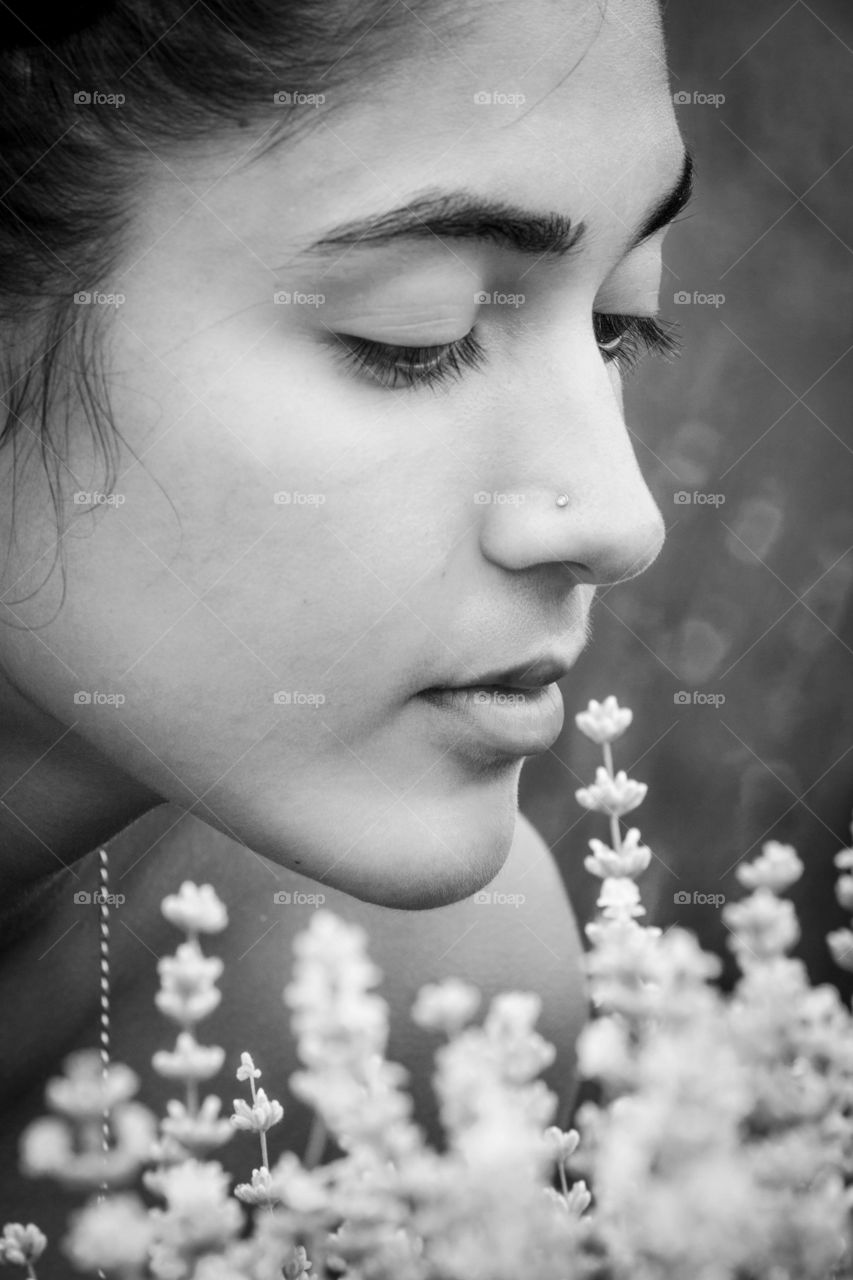 Profile of a beautiful teen girl with white flowers