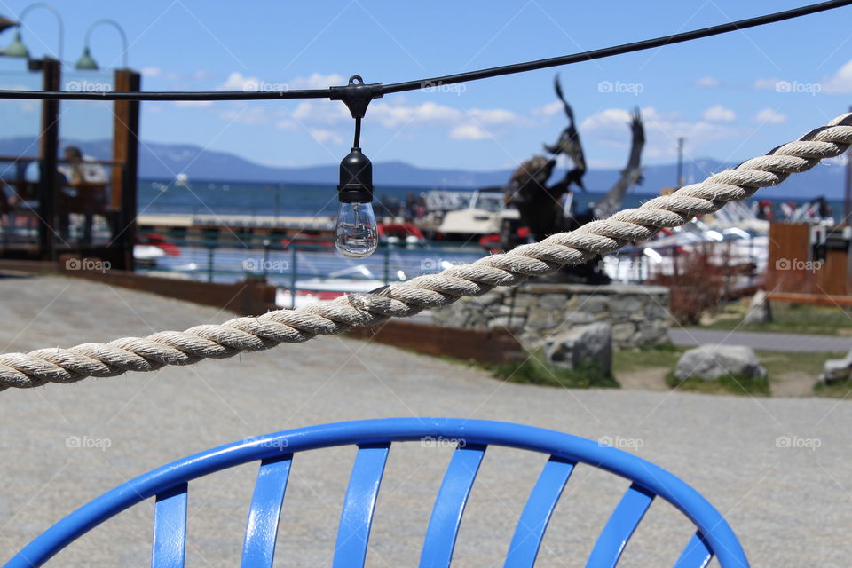 blue chair, Lake Tahoe in the background. Sitting at a restaurant in Lake Tahoe taking in this beautiful spectacular View.