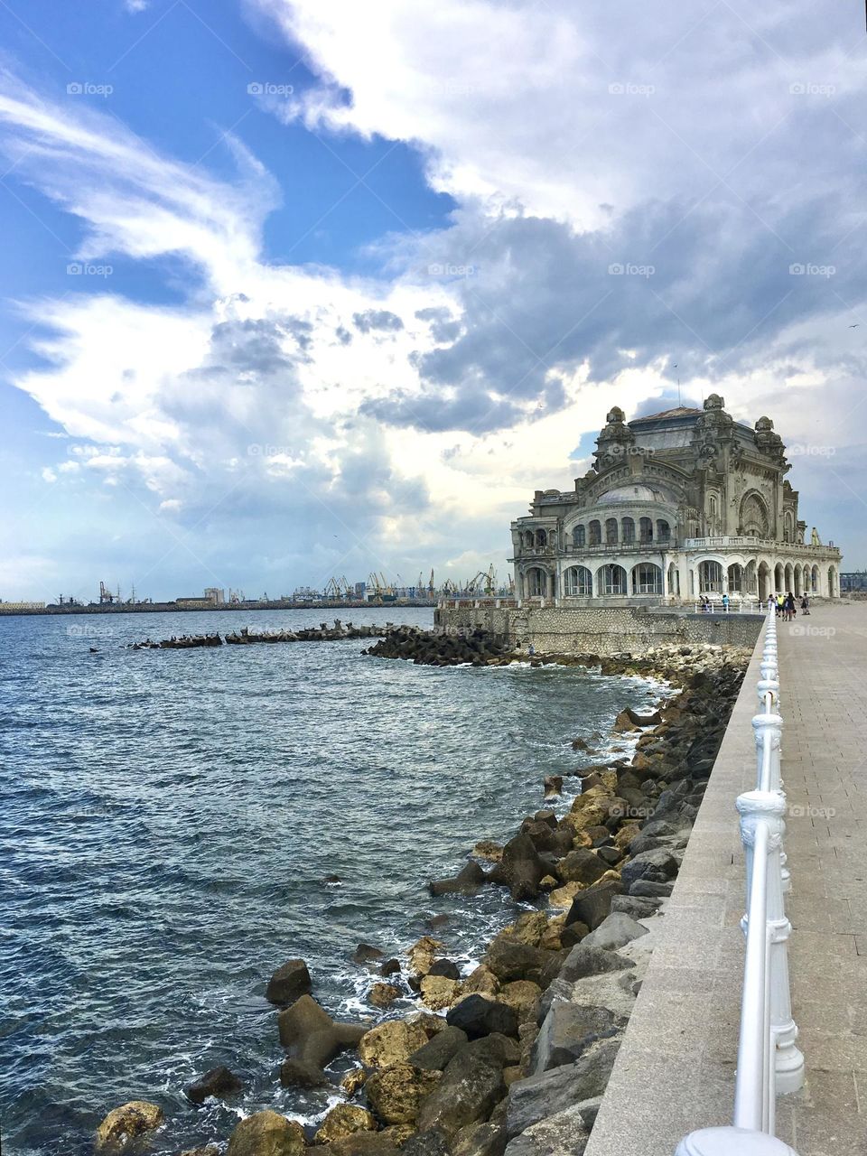 Black Sea shore during a cloudy day with Constanta Casino in the background 