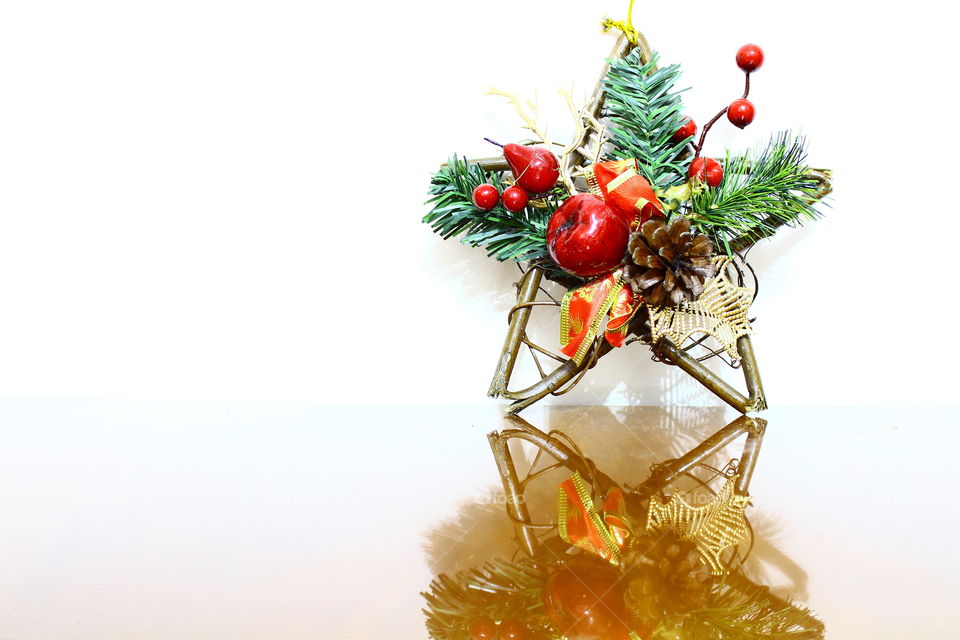 Christmas wooden star with decorations on a wooden table