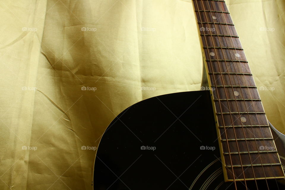 acoustic guitar on Golden textile