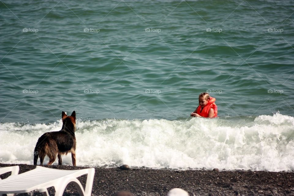 Girl with dog at the beach 