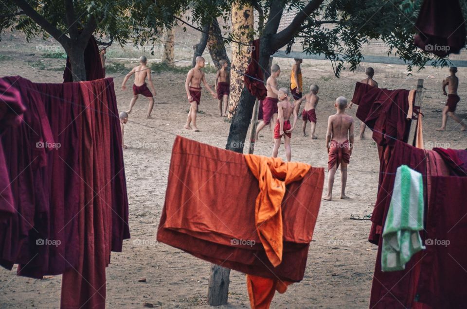 A group of children monks playing football barefoot