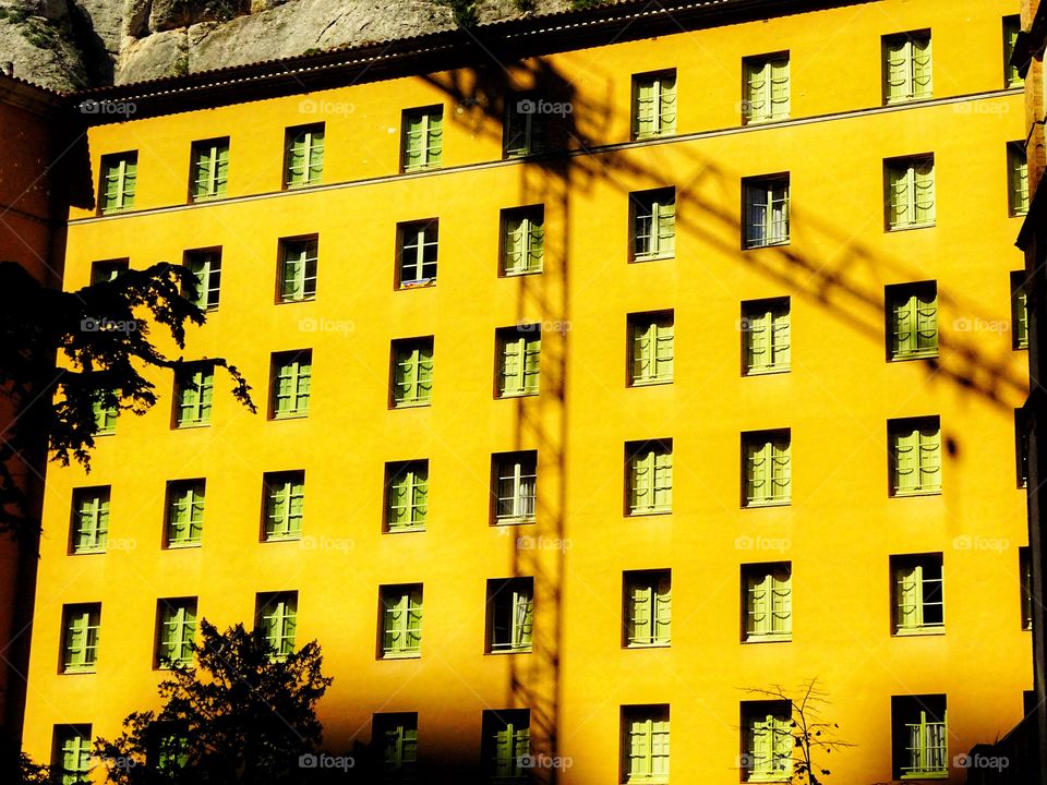 The colored building and the shadow of the crane