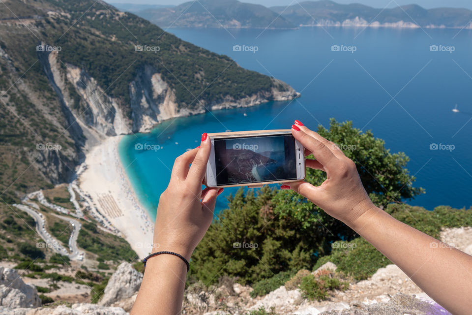 Photographing famous Myrtos Beach in Kefalonua Greek island