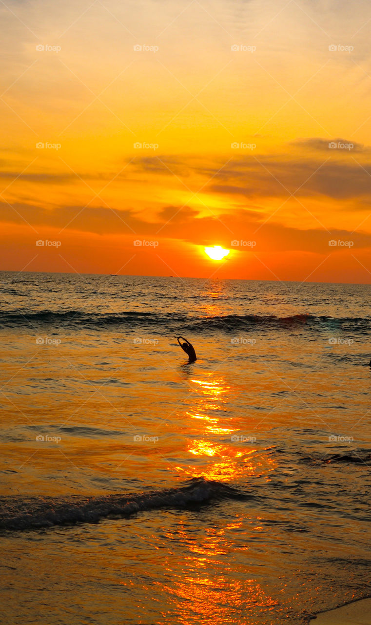 Stretching in the ocean while watching a magnificent sunset in Thailand.  It doesn't get much better than this.