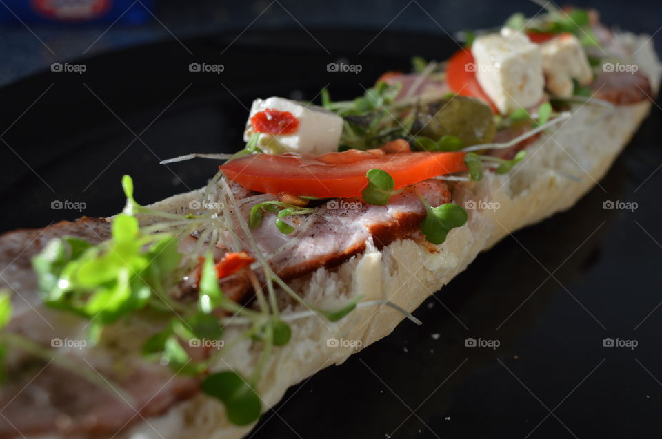 Sandwich with ham, tomato, feta cheese