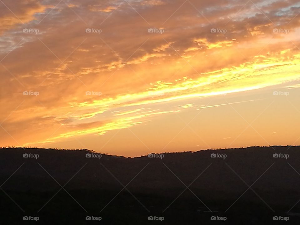 The sun rises on the mountains of the countryside in the area of Beira Baixa, Portugal.