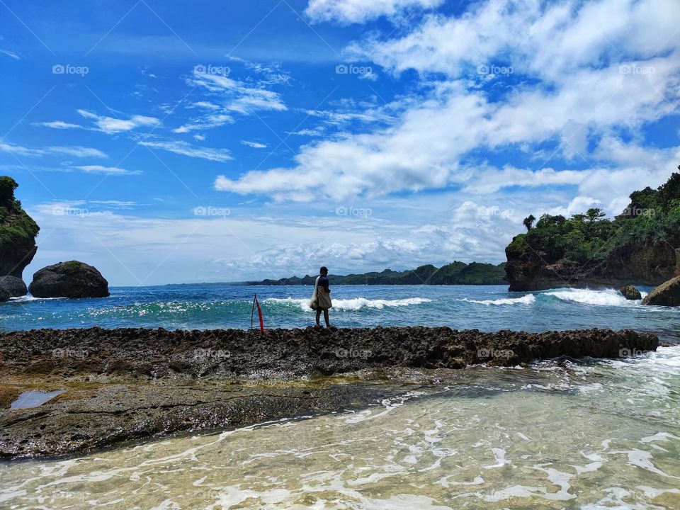 fishermen catch fish on rocky shore