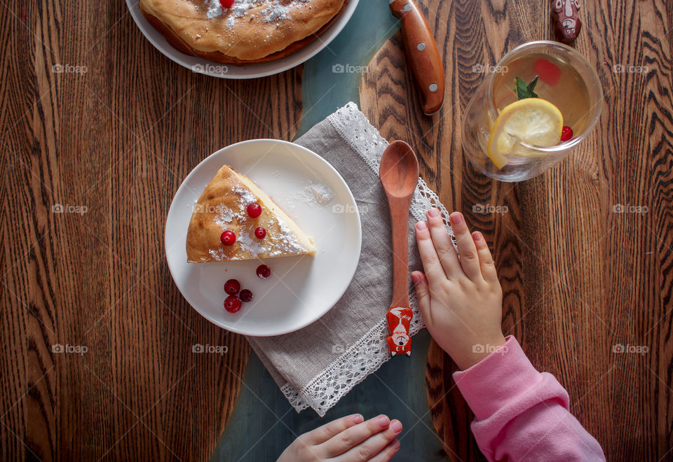 Children breakfast with cheesecake. Hands, detail