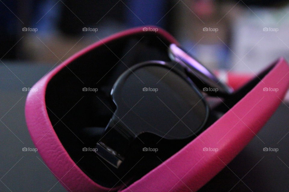 Close-up of sunglasses on pink box