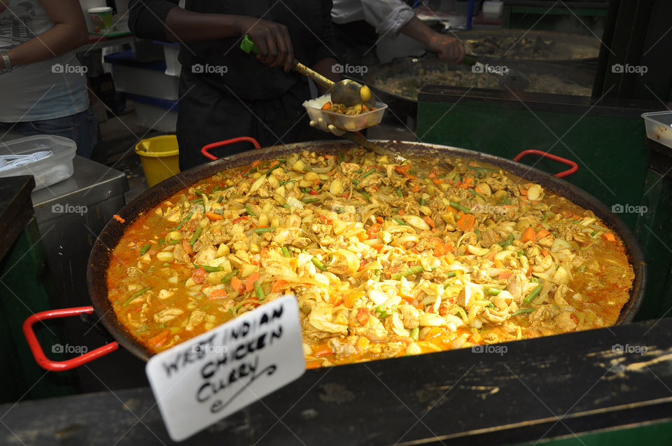 A huge pot of West Indian chicken curry gumbo is served up at the Borough market in London.