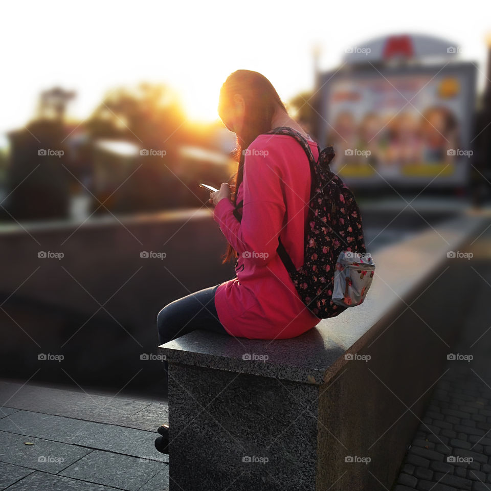 Young woman reading a massage on her mobile phone 