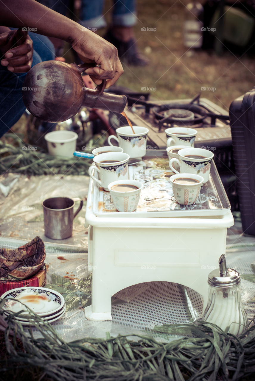 Fresch burned coffe beans. Iternational BBQ. Friend from Eritrea prepare for us coffee with a traditional coffee drinking culture.