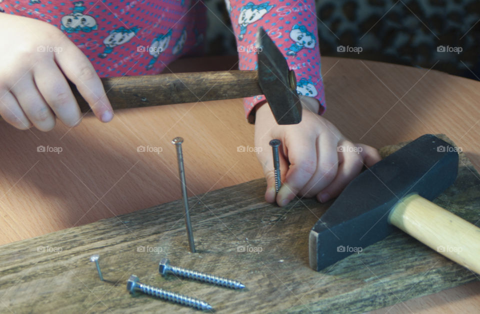 little girl holding tools