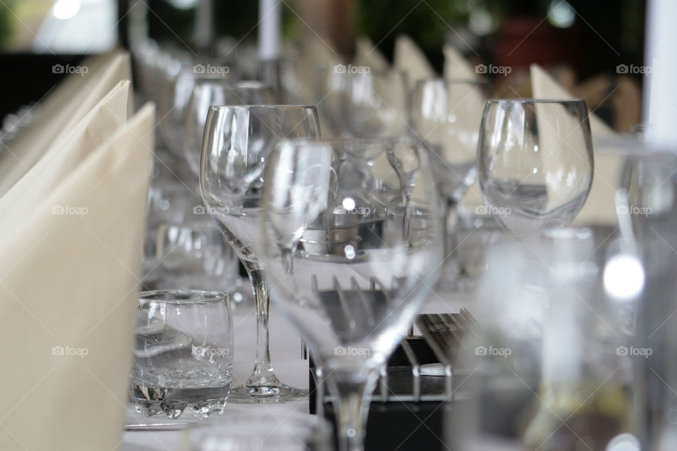 wine glasses on a decorated table. the line of empty glasses on a table set for a wedding