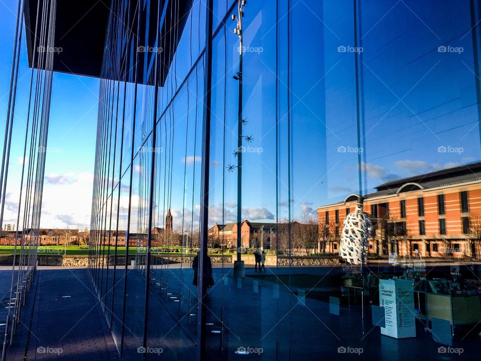 Public buildings are reflected in the large windows of MIMA, the Middlesbrough Institute of Modern Art in the UK 
