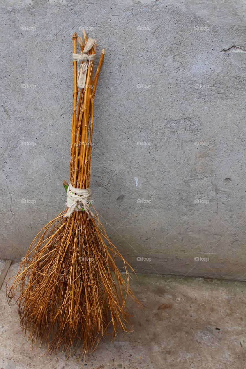 Broomstick on gray background