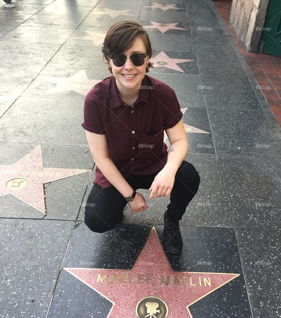 Girl Posing for Photo with the Marlee Matlin Hollywood Walk of Fame Star