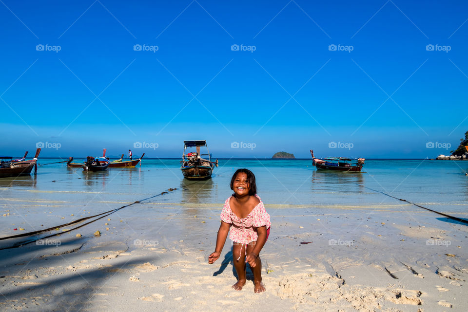 Cute kid on the beach at beautiful LiPe island Thailand
