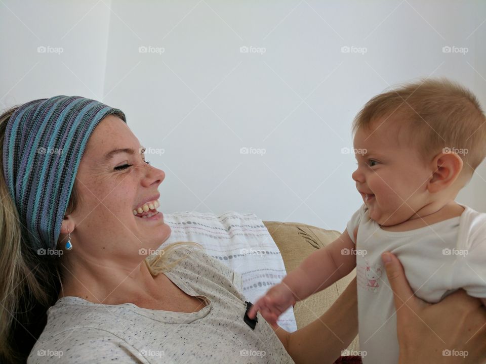 Mum and cute baby laughing.