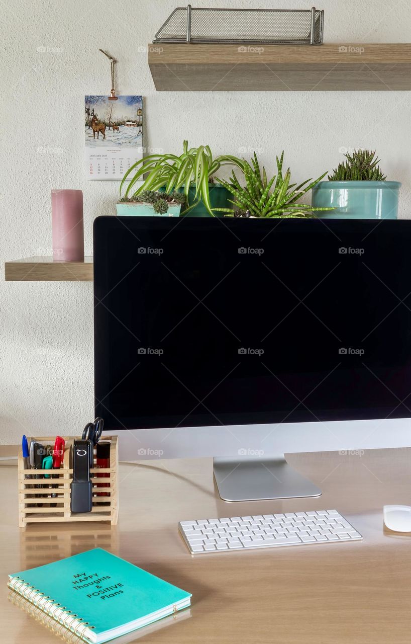 Desk with plants, candle and notepad