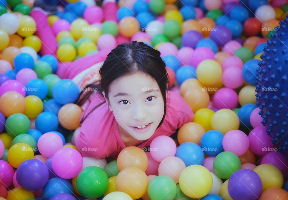 Asian long hair girl playing colorful ball