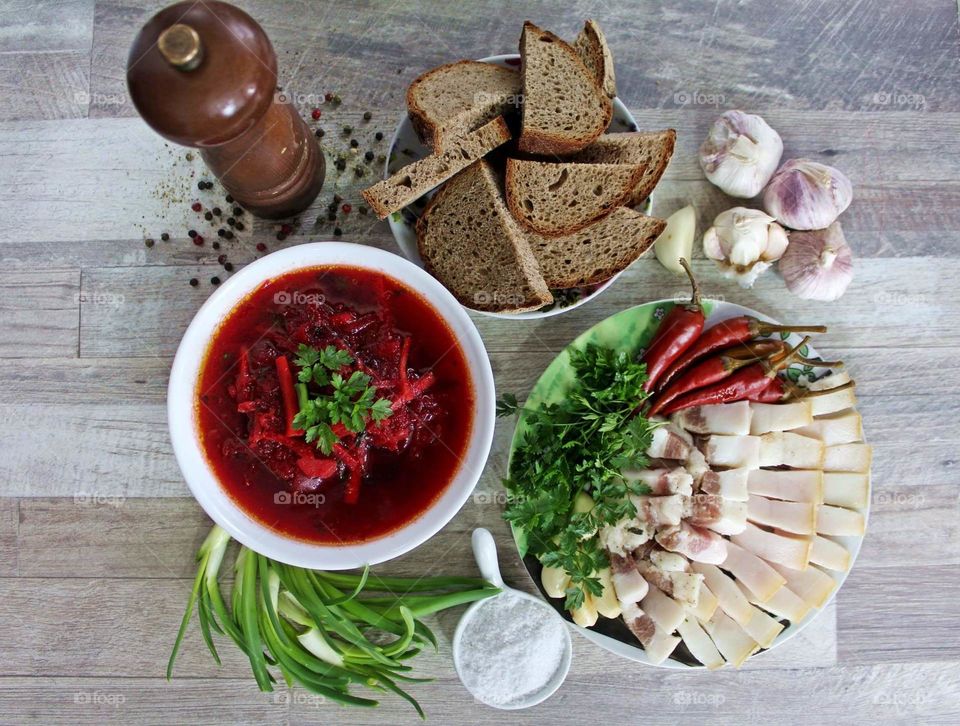 Beetroot soup (Ukrainian borsch) with bread, lard, garlic and greens.