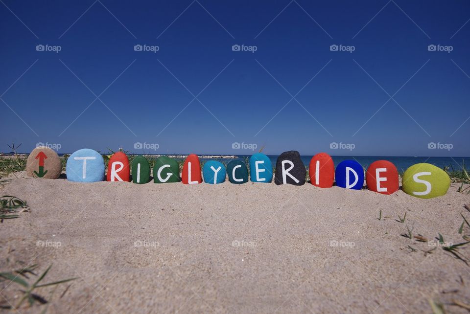 Triglycerides on colouful stones over the sand