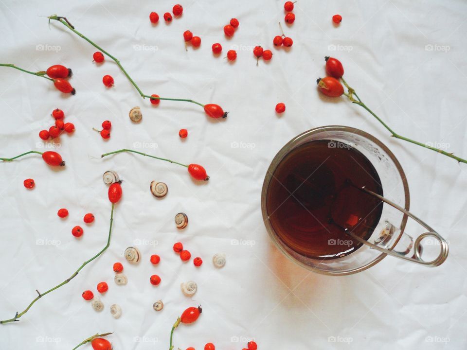 Cup of tea and berries wild rose