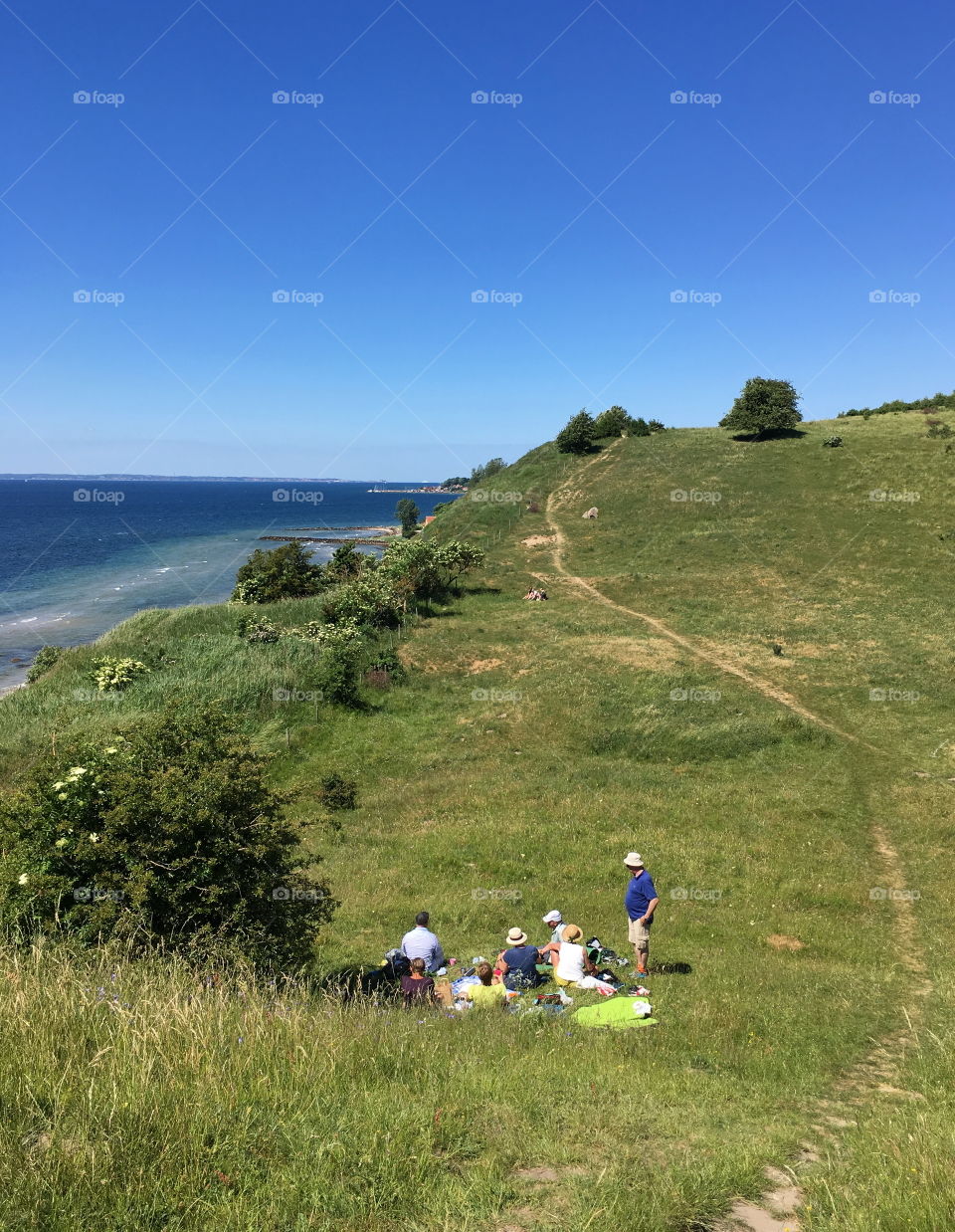 Pick-nick in the grass, hikers in Skåne, Sweden