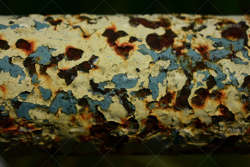 Old fence railing with rust and peeling paint