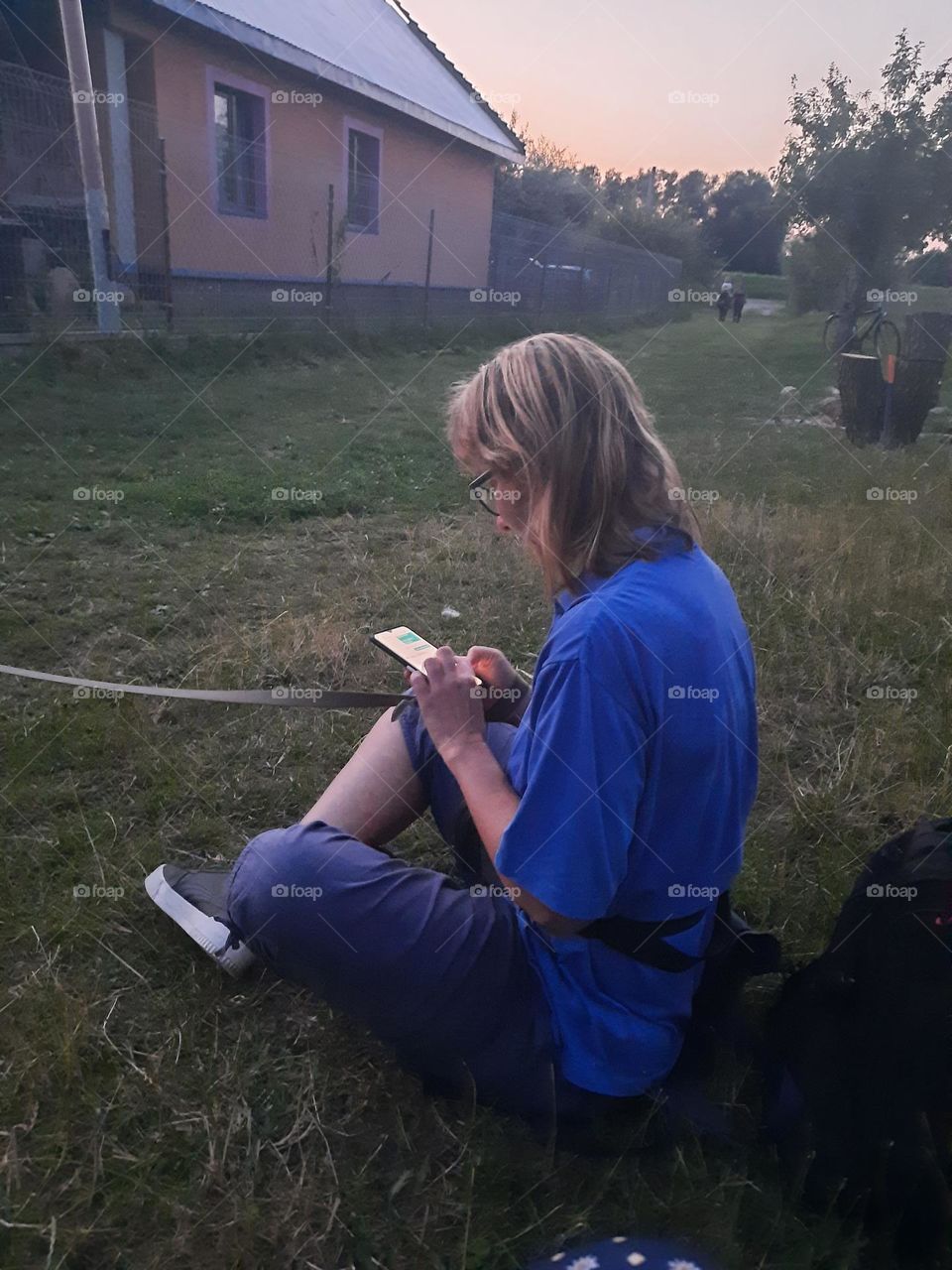 young woman on her phone at summer evening