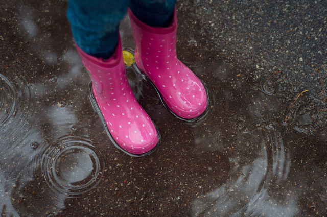 Rubber boots in a puddle
