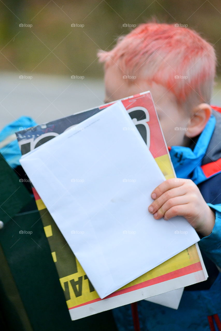 Boy getting letters from the mailbox