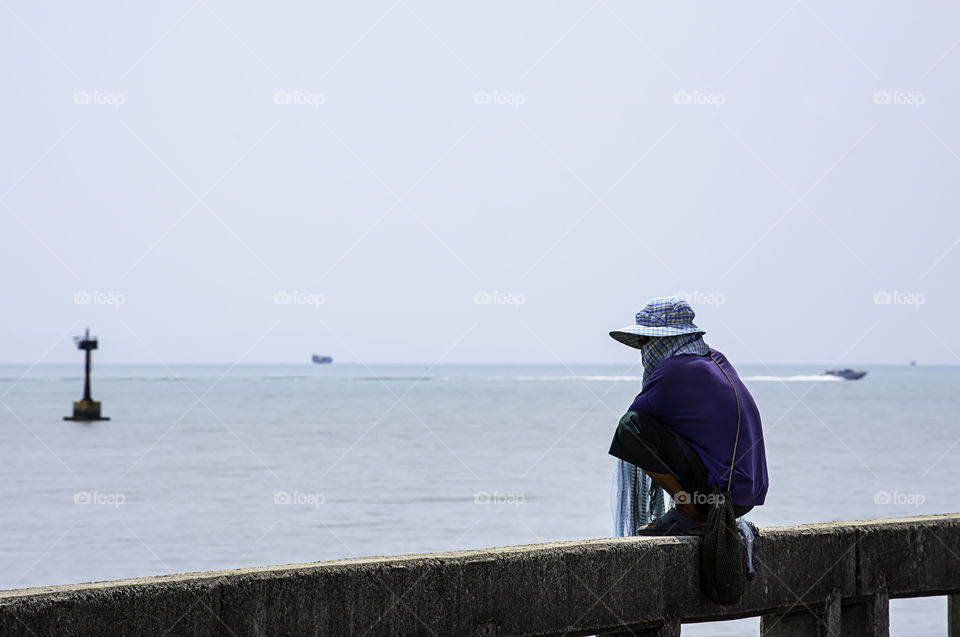 Man holding fishing nets  Background sea and sky.