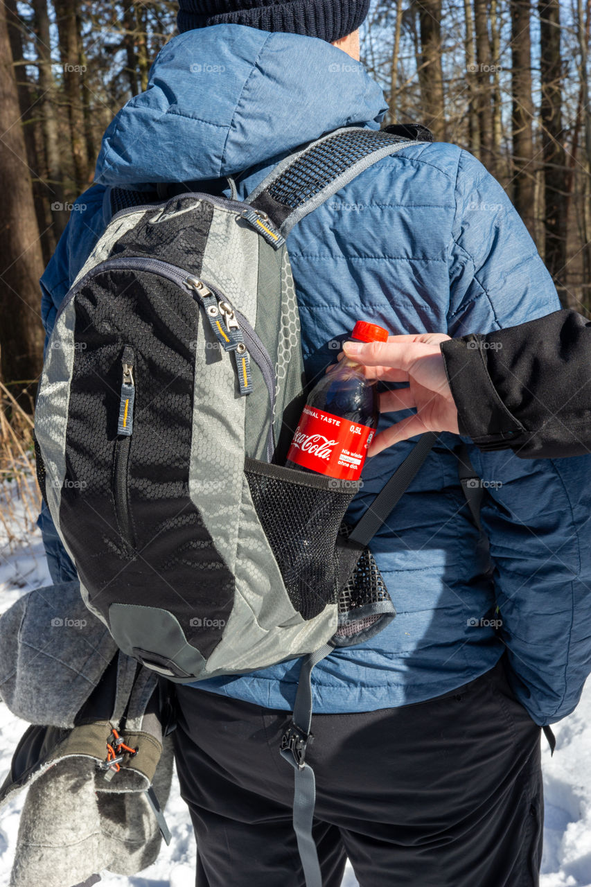 backpack and a bottle of Coca Cola