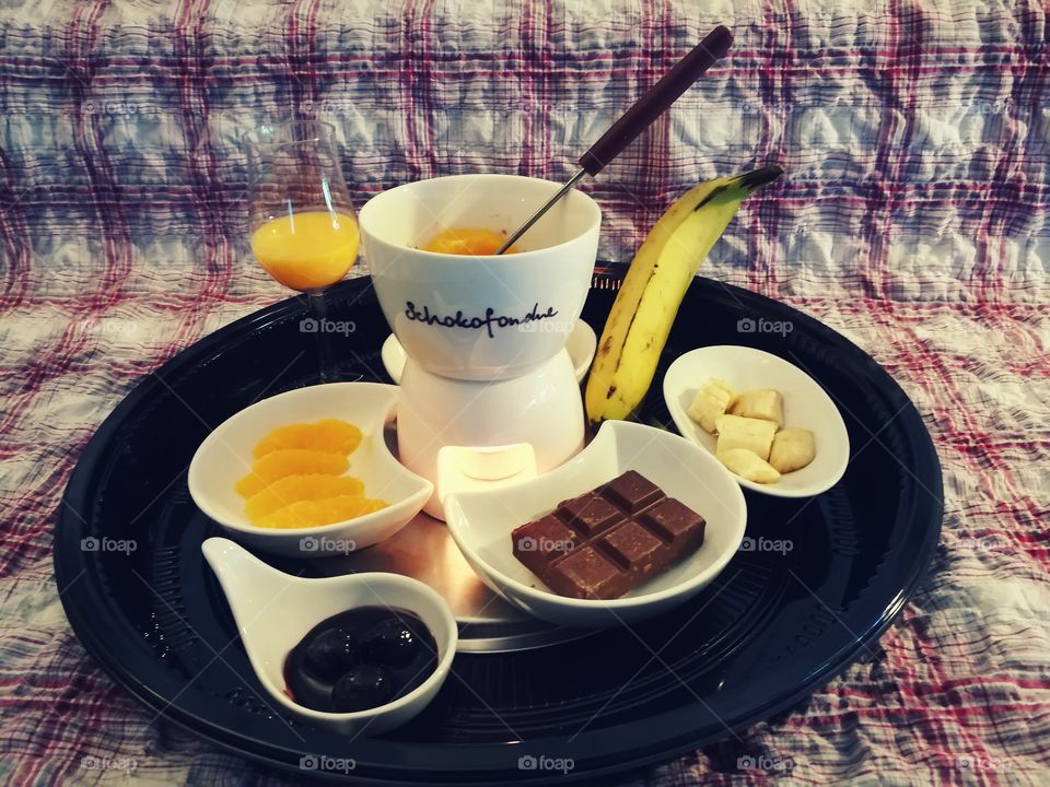 Chocolate fondue with banana, cherries  and orange
