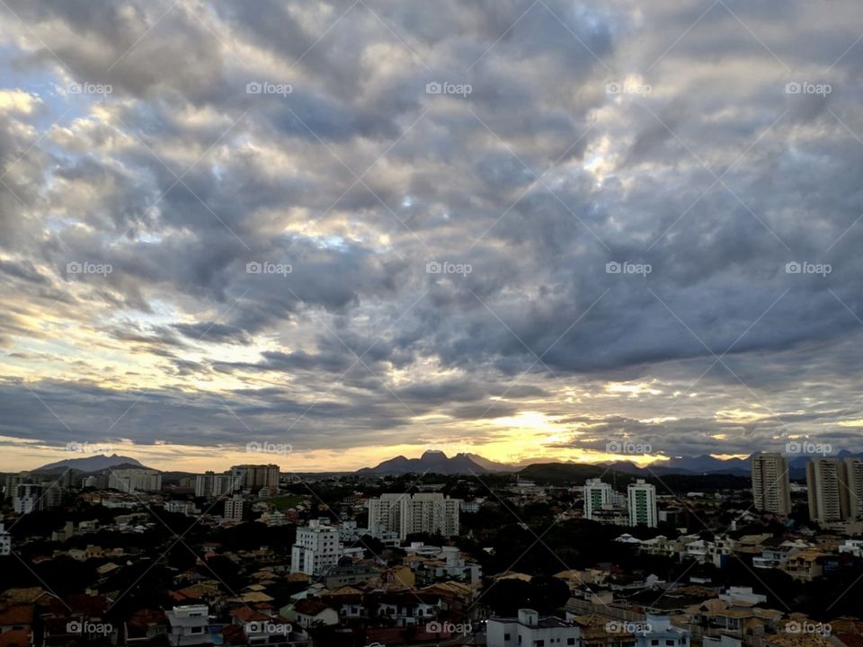 Everybody towards the sunset. Beautiful clouds and the city.