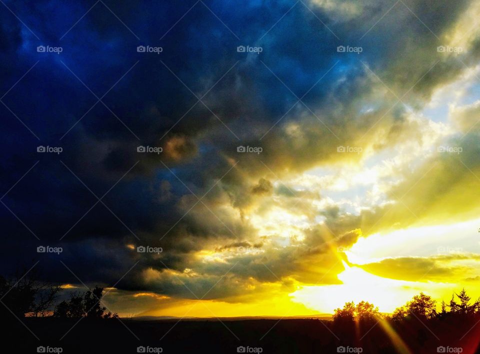 Landscape silhouette with sunset colored sky