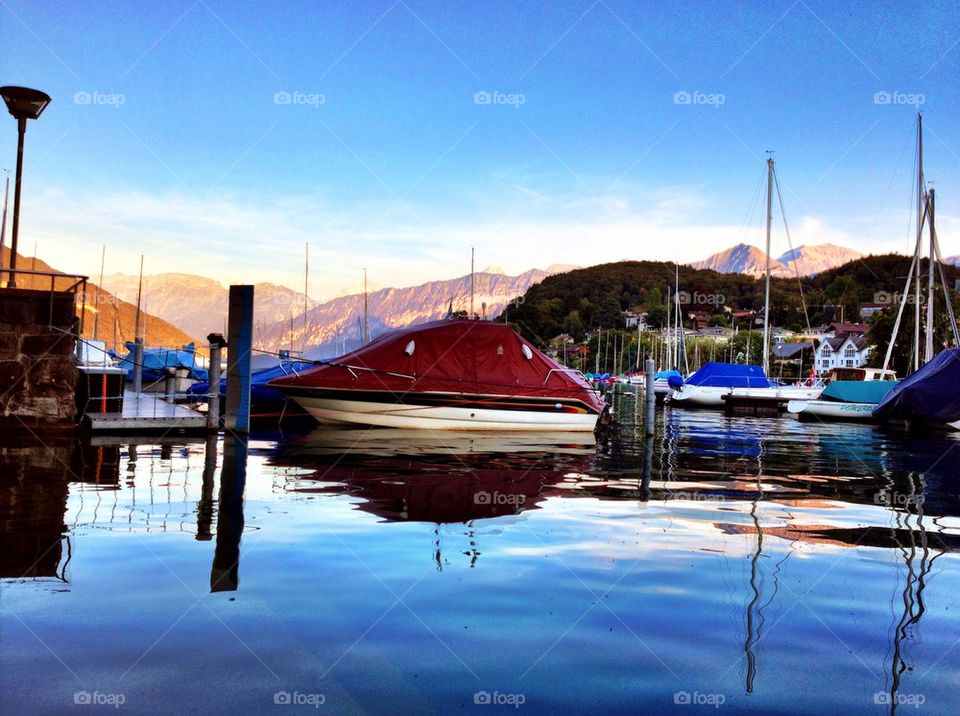 Lake with boats surrounded with mountains