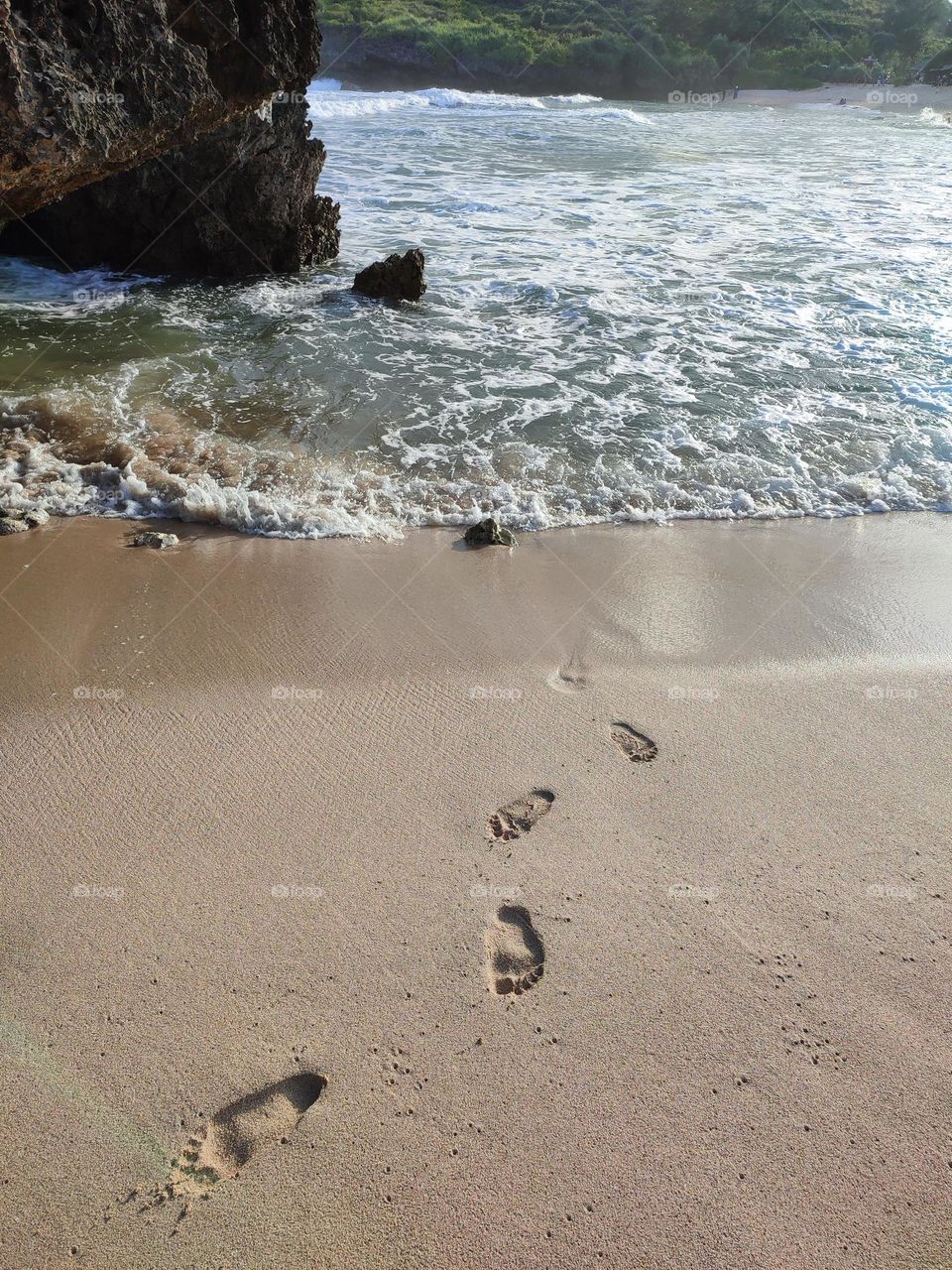 footprints in the beach sand