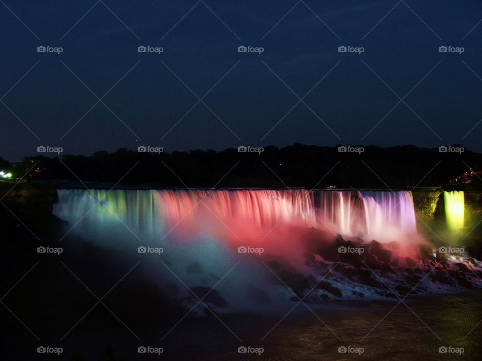 Illuminated waterfall at night