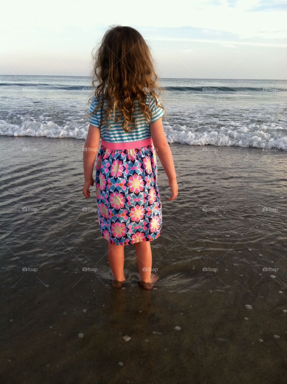 Innocent little girl gazed at the enormity of the vast ocean at Emerald Isle North Carolina 